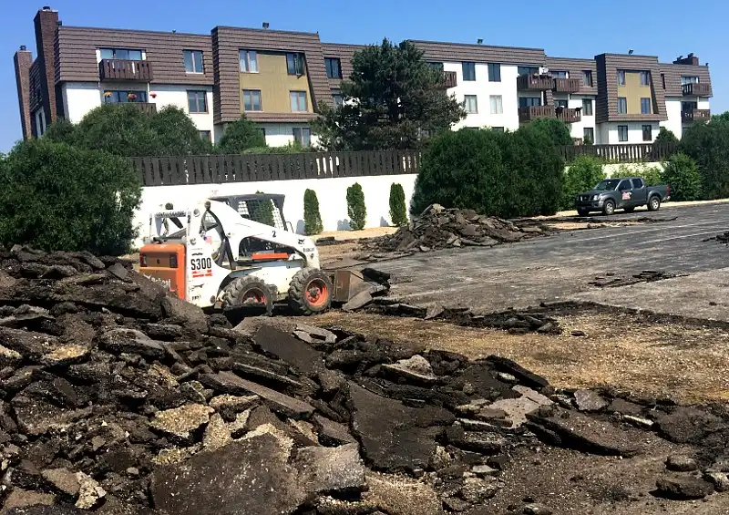 destroying old asphalt by paving contractors Grayslake
